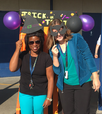 Two teachers with props for Halloween